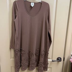 Brown knit dress with rosette detail at hem.